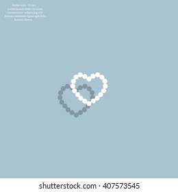 Pearl beads as heart on a white background