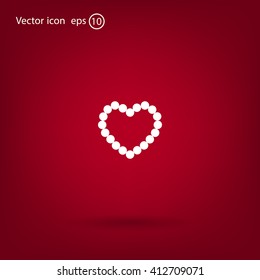 Pearl beads as heart on a white background