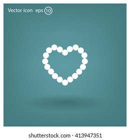 Pearl beads as heart on a white background