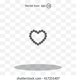 Pearl beads as heart on a white background
