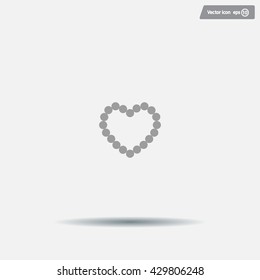 Pearl beads as heart on a white background