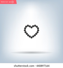 Pearl beads as heart on a white background