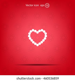 Pearl beads as heart on a white background