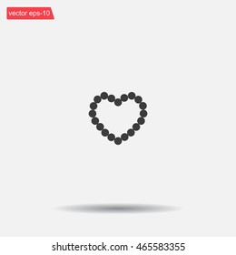 Pearl beads as heart on a white background