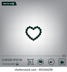 Pearl beads as heart on a white background