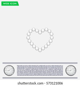 Pearl beads as heart on a white background