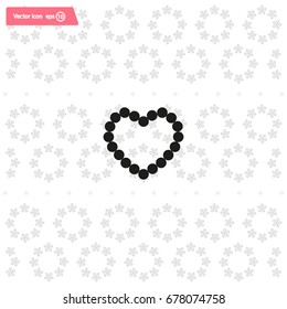 Pearl beads as heart on a white background