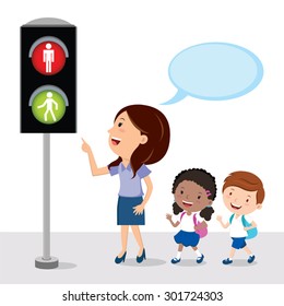 Pedestrian traffic light. Teacher showing the school kids traffic light sign with go and stop indicators.