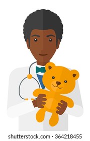 Pediatrician holding teddy bear.
