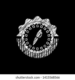 pen icon inside chalk emblem written on a blackboard