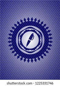 pen icon inside emblem with jean background
