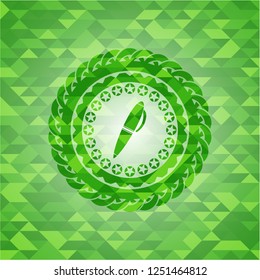 pen icon inside green emblem with mosaic background