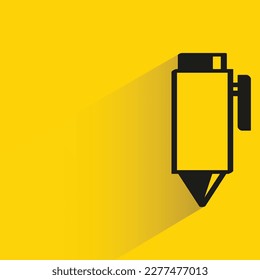 pen with shadow on yellow background