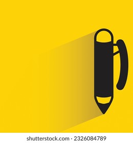 pen with shadow on yellow background