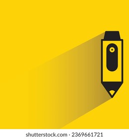pen with shadow on yellow background