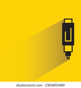 pen with shadow on yellow background