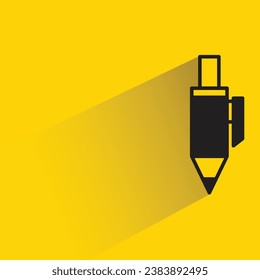 pen with shadow on yellow background
