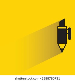 pen with shadow on yellow background