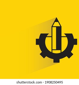 pencil and gear drop shadow on yellow background