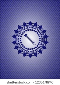 pencil icon inside emblem with denim texture