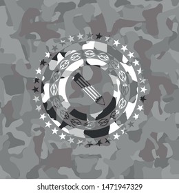 pencil icon inside grey camo emblem
