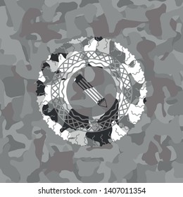 pencil icon inside grey camouflage emblem