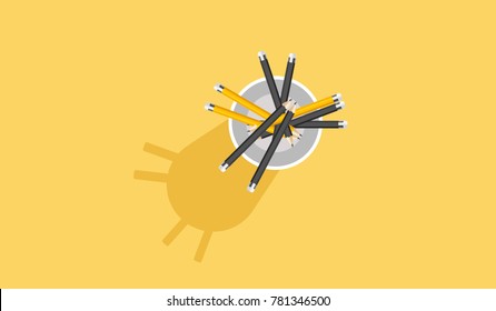 Pencils inside a mug on yellow background
