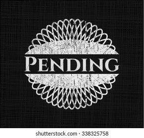 Pending chalk emblem written on a blackboard