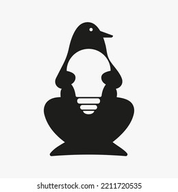 Penguin Bulb Logo Negative Space Concept Vector Template. Penguin Holding Bulb Symbol