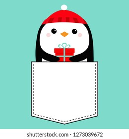 Penguin head face holding gift box. Red hat. T-shirt pocket. Merry Christmas. Happy New Year. Cute cartoon kawaii baby character. Arctic animal. Flat design. Hello winter. Blue background. Vector
