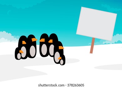Penguins looking a blank sign