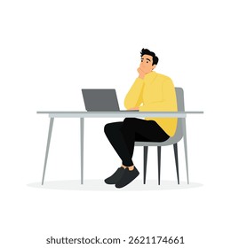 Pensive man sitting at a desk with a laptop in a modern workspace
