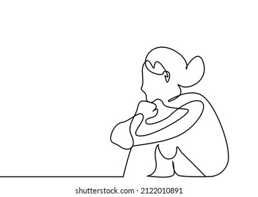 pensive woman sitting on floor looking away daydreaming