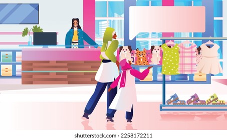 people in boutique choosing and buying trendy clothes in kids clothing store big sale shopping concept