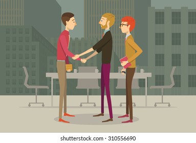 People in business casual outfits giving each other an agreement handshake 