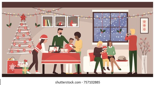 People celebrating Christmas together at home: family connecting with mobile devices and a laptop, homosexual couple with their son posing for a picture and sweets on the table