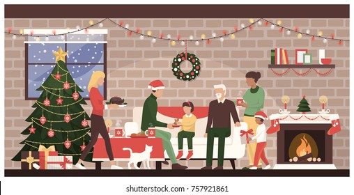 People celebrating Christmas together at home: traditional family with kids eating sweets next to the fireplace and decorated Christmas tree