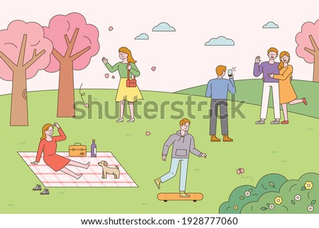 People are doing outdoor activities in a park where spring flowers bloom. People having picnics, riding boards, and taking pictures. flat design style minimal vector illustration.