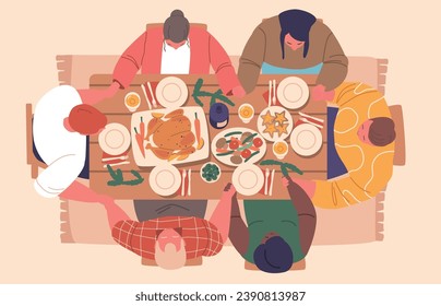 People Gathered Around The Festive Christmas Table Top View, Family or friends Bow In Prayer, Hands Intertwined