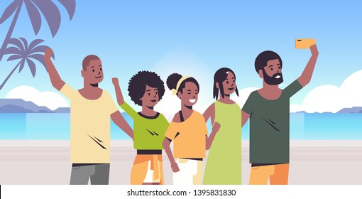 people group on beach taking selfie photo on smartphone camera summer vacation concept african american friends standing together tropical island seaside background portrait horizontal