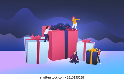 People are having fun on big gift boxes for Christmas. Small children dance and walk. New Year concept. Merry christmas atmosphere.