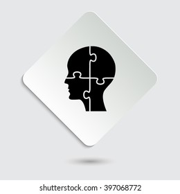 People head with puzzles elements - black vector icon  on a paper button