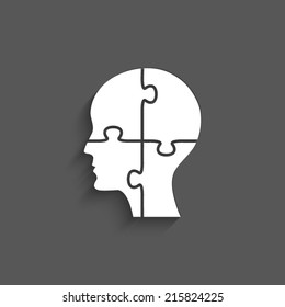 People head with puzzles elements on a grey background