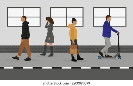 People move along the sidewalk in different directions against the background of a wall with windows
