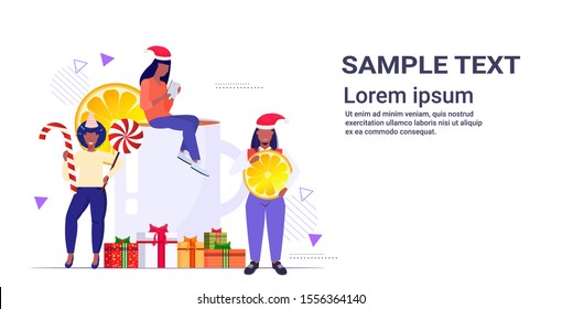 people near christmas drink mulled wine holding candy cane lollipop and orange slice winter holidays celebration concept horizontal copy space full length sketch vector illustration