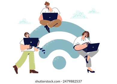 People near large WiFi symbol use laptops to perform remote work and receive online education. Office workers use WiFi network with free access to connect to carparative cloud or exchange media files