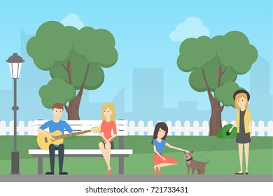 People In Park. Teens Playing Guitar And Petting Dog.