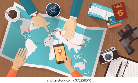 People planning a trip around the world, they are pointing on a map and using an app on a mobile phone, travel and vacations concept