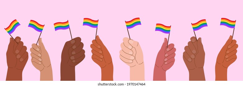 People at the pride parade hold flags and posters with the LGBT symbol. The right to self-affirmation and equality. Celebrating Pride Month against discrimination and violence.