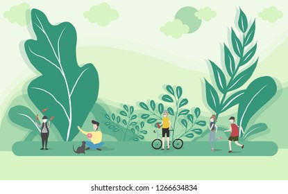 People relaxing in nature in a beautiful urban park, city skyline on the background
